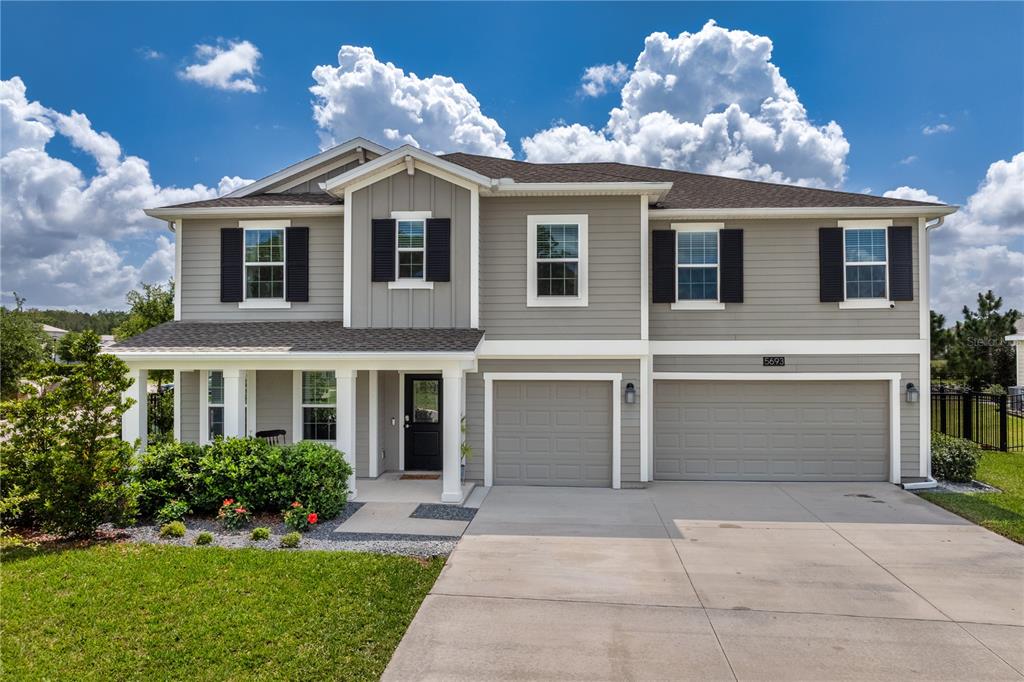 5693 Alenlon Way Mount Dora, FL 32757 - Photo 1 of 40 a front view of a house with a yard and garage