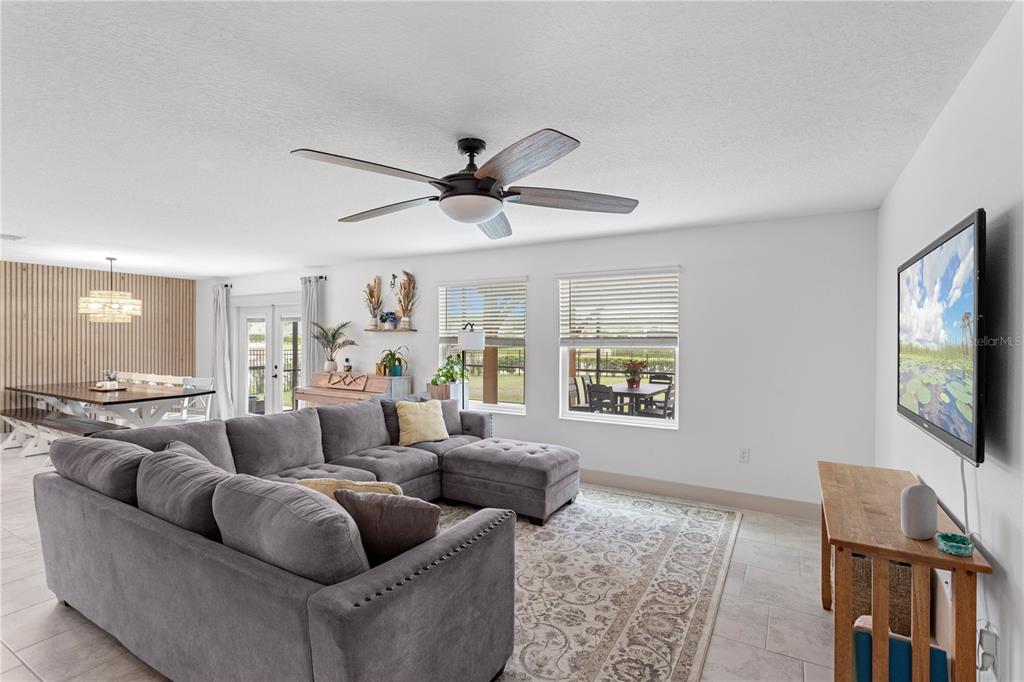 5693 Alenlon Way Mount Dora, FL 32757 - Photo 14 of 40 a living room with furniture ceiling fan and a window