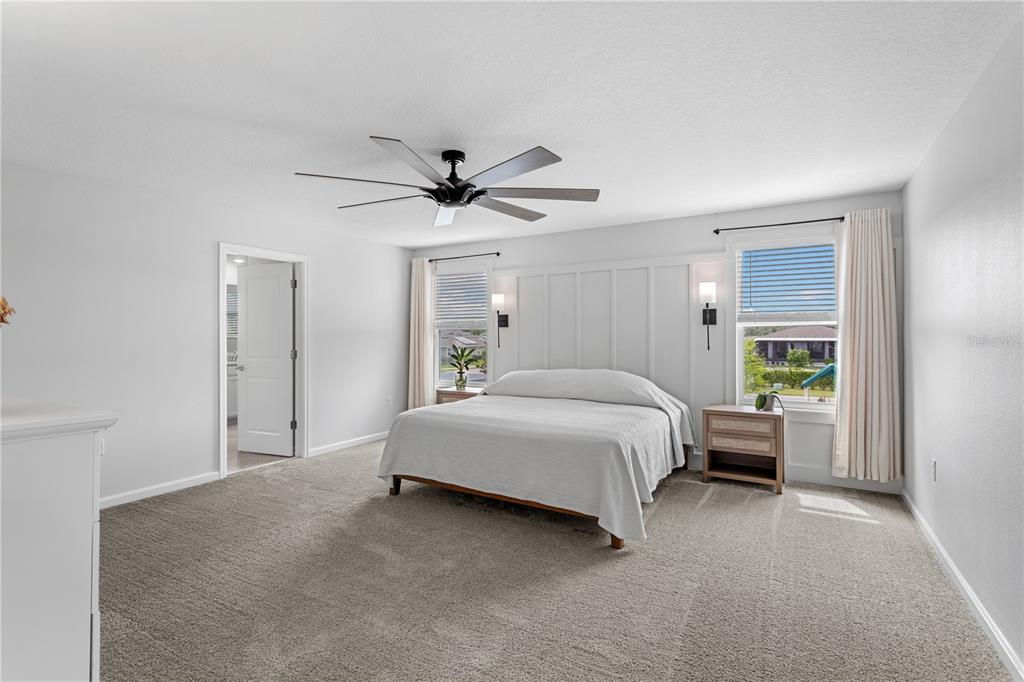 5693 Alenlon Way Mount Dora, FL 32757 - Photo 21 of 40 a spacious bedroom with a bed and a window