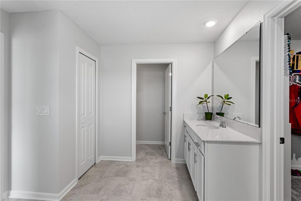 5693 Alenlon Way Mount Dora, FL 32757 - Photo 25 of 40 a bathroom with a sink a tub and a mirror