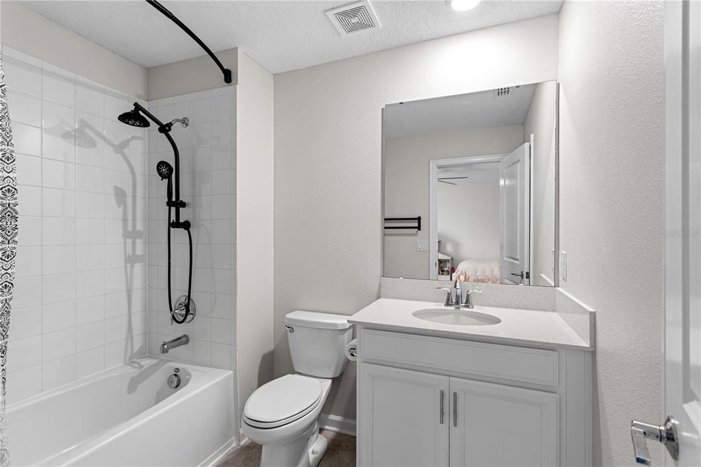 5693 Alenlon Way Mount Dora, FL 32757 - Photo 28 of 40 a bathroom with a sink toilet and shower