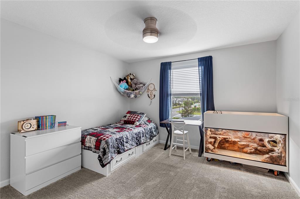 5693 Alenlon Way Mount Dora, FL 32757 - Photo 30 of 40 a bedroom with a bed and a window