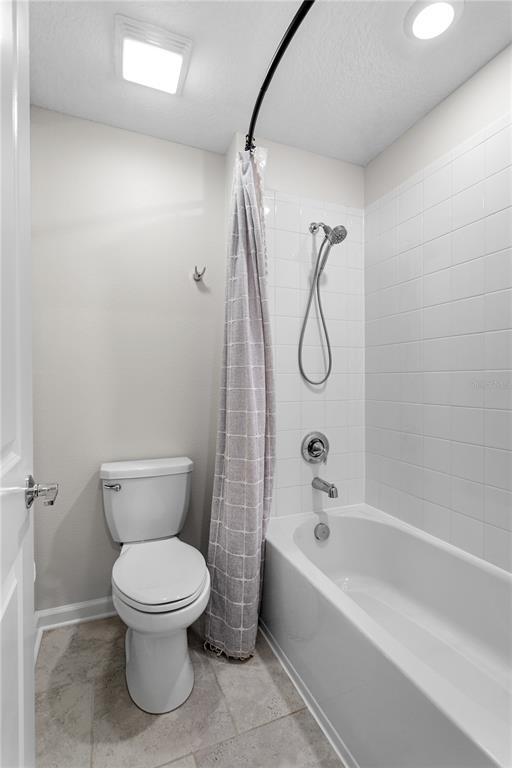5693 Alenlon Way Mount Dora, FL 32757 - Photo 32 of 40 a bathroom with a toilet and a bath tub