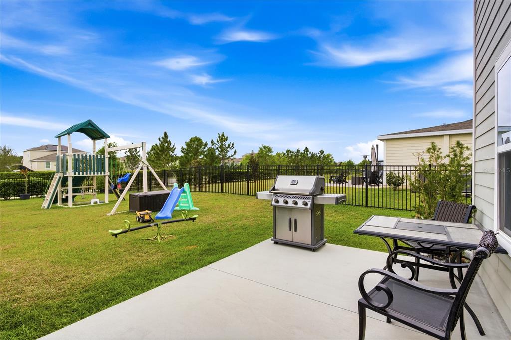 5693 Alenlon Way Mount Dora, FL 32757 - Photo 36 of 40 a view of a backyard with swimming pool