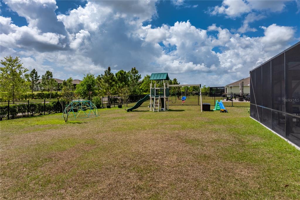 5693 Alenlon Way Mount Dora, FL 32757 - Photo 38 of 40 a view of a park with swings and slides