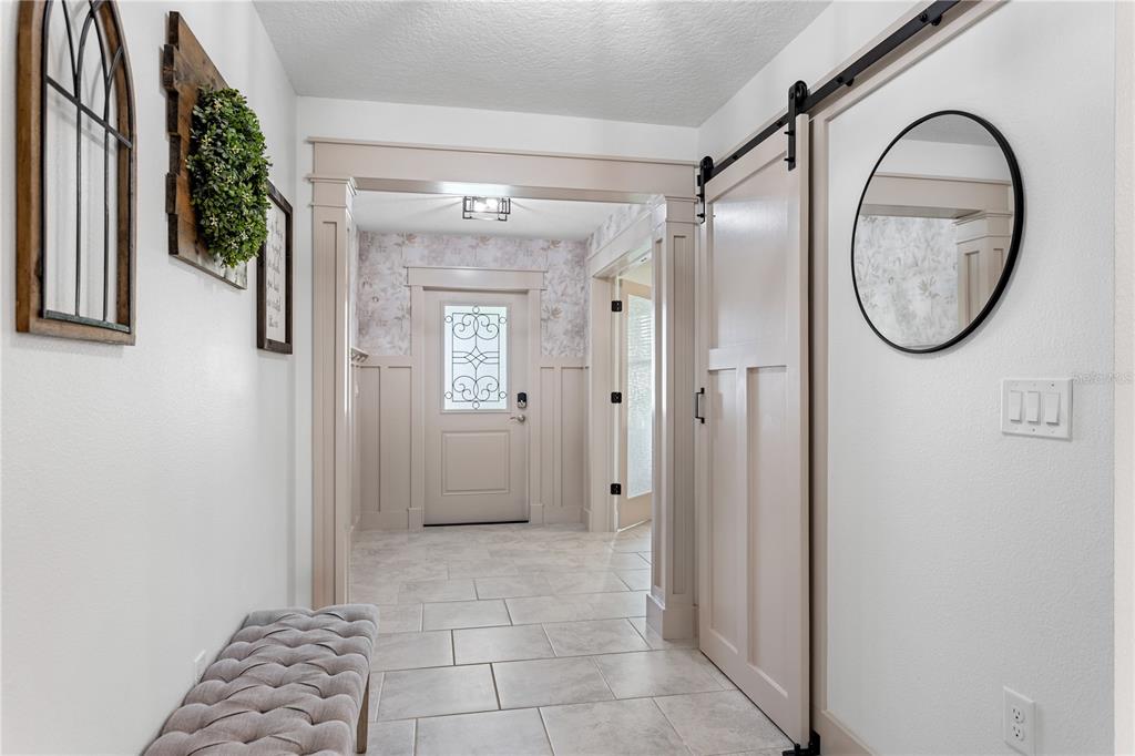 5693 Alenlon Way Mount Dora, FL 32757 - Photo 6 of 40 a view of a bathroom with a shower and a mirror