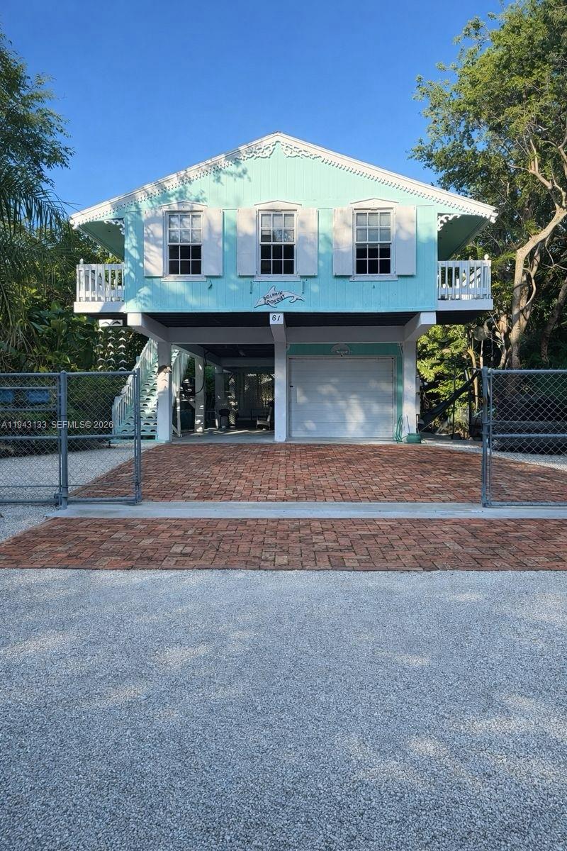 61 Central Avenue Key Largo, FL 33037 - Photo 1 of 21 a front view of a house with garden