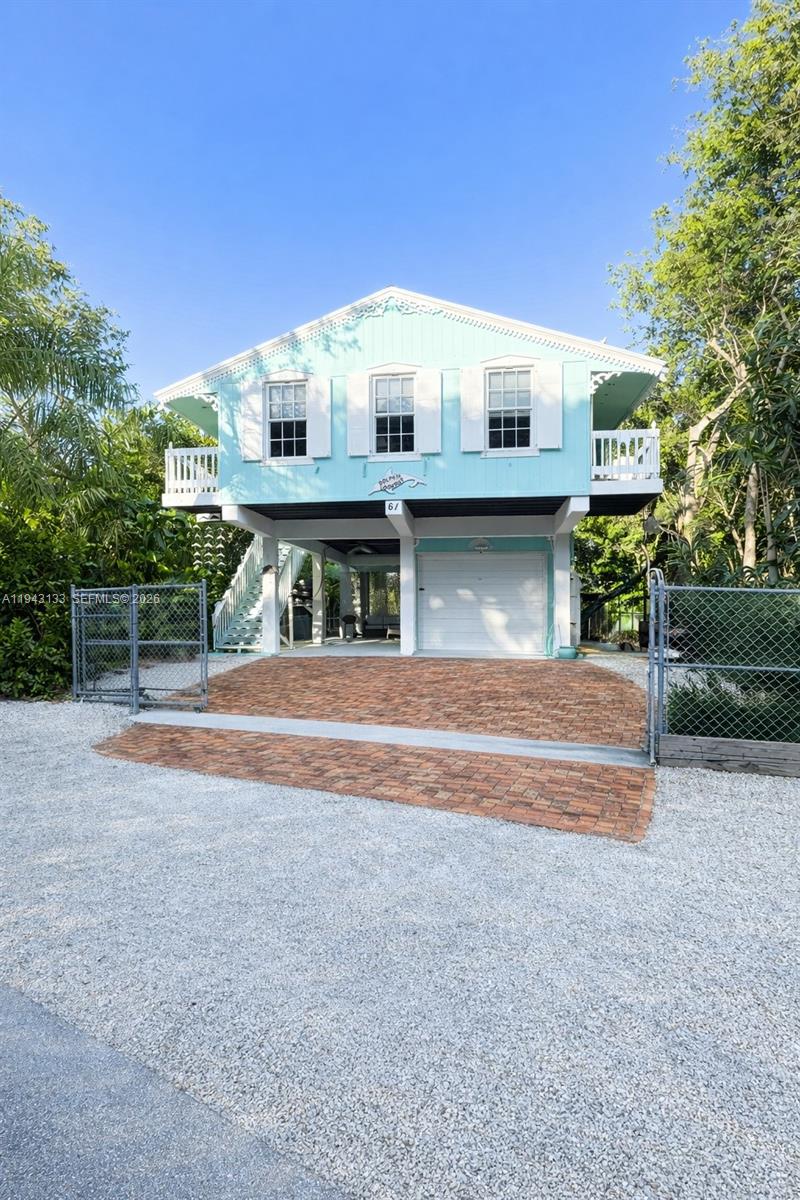 61 Central Avenue Key Largo, FL 33037 - Photo 2 of 21 a view of house with a yard and potted plants