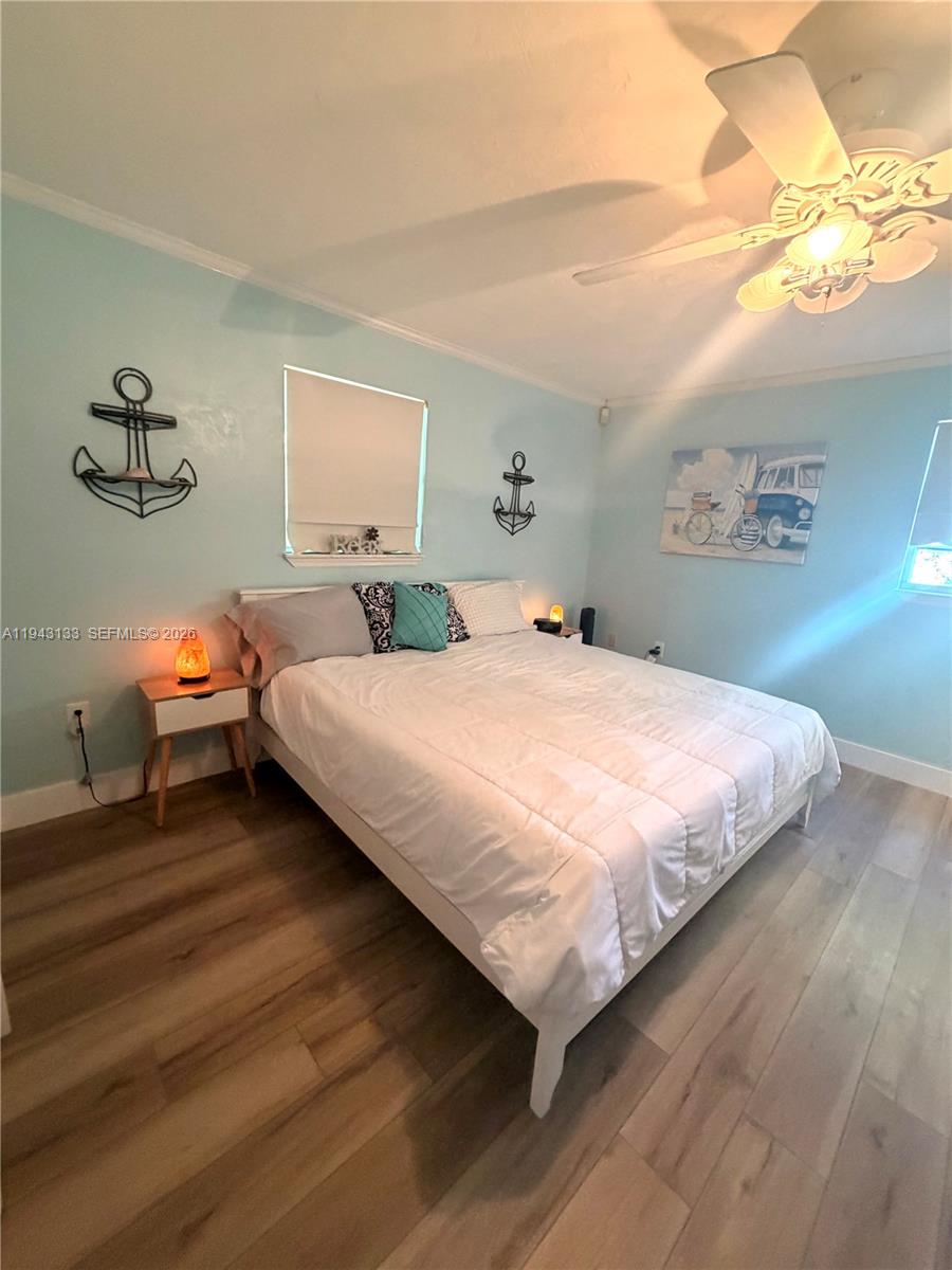 61 Central Avenue Key Largo, FL 33037 - Photo 7 of 21 a bedroom with bed and a night stand