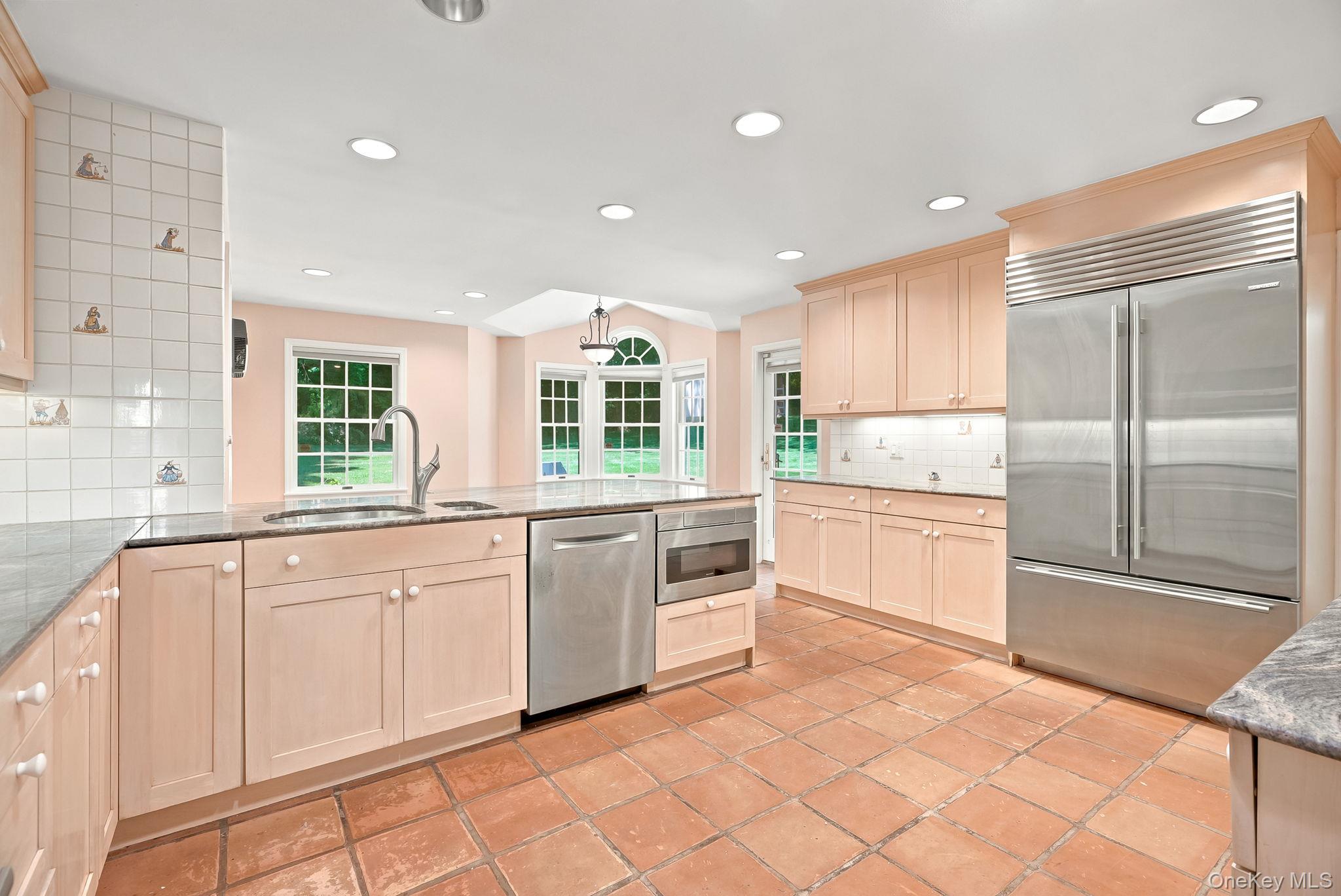 1 Sheridan Road Scarsdale, NY 10583 - Photo 10 of 40 Chef's Kitchen/Great Room with stainless steel appliances including SubZero fridge