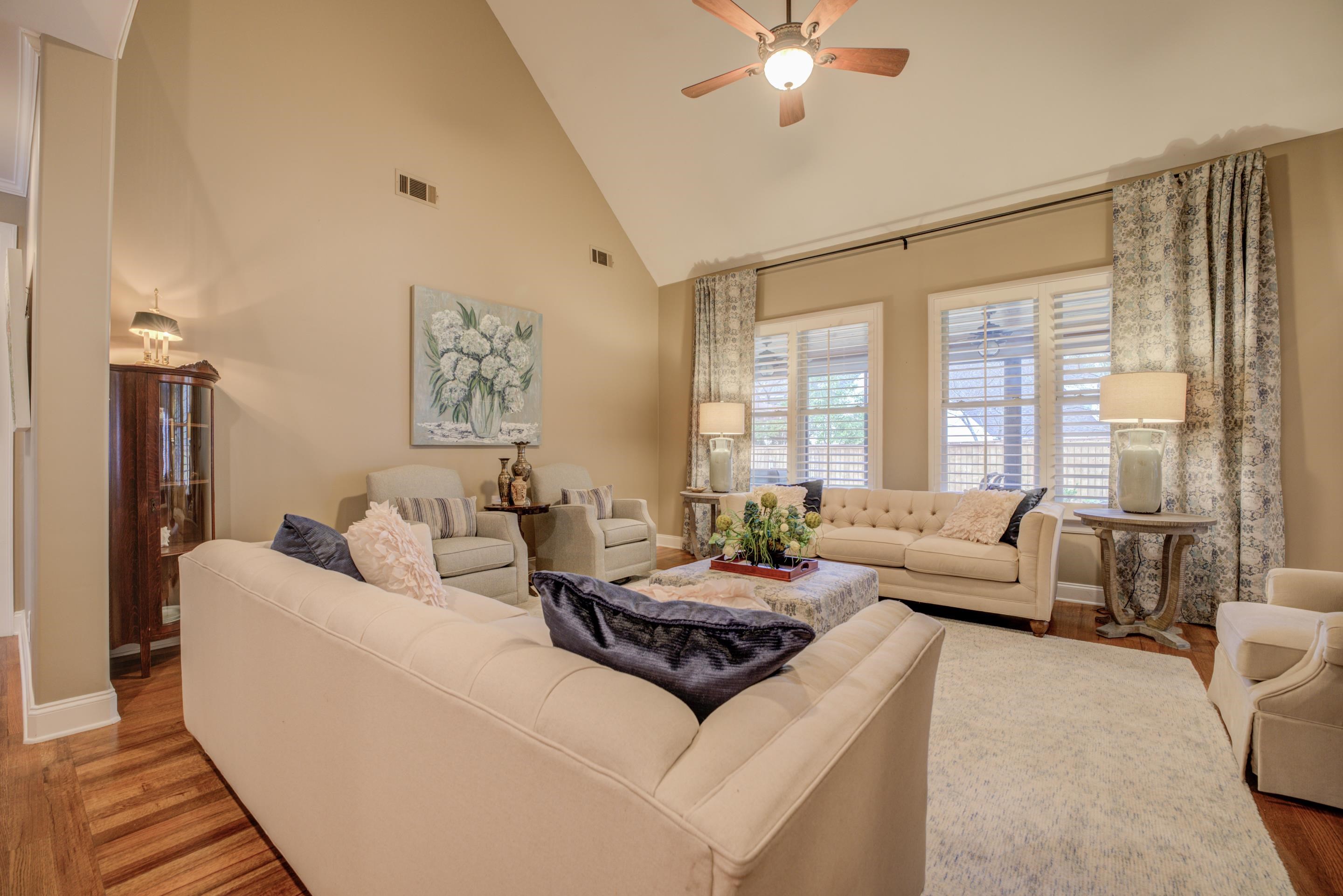 1238 Braystone Trail Collierville, TN 38017 - Photo 9 of 40 Living Room featuring high vaulted ceiling, hardwood floors. Plantation shutters across rear windows as well.