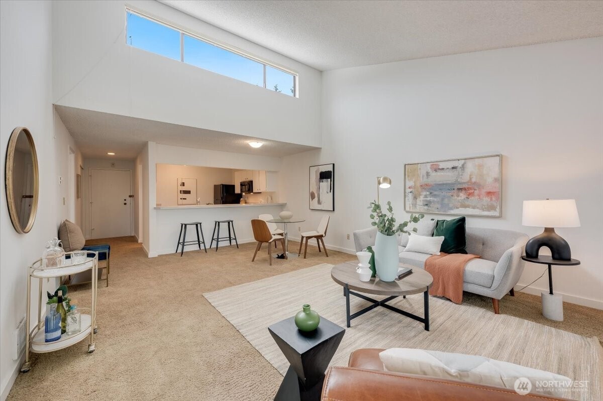 13680 Northeast 69th Street, Unit 656 Redmond, WA 98052 - Photo 13 of 33 a living room with furniture and a flat screen tv