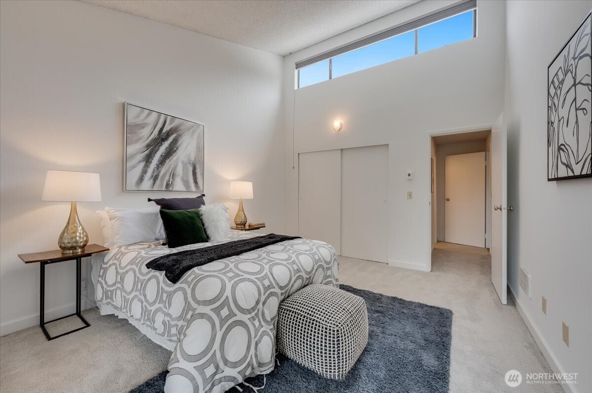 13680 Northeast 69th Street, Unit 656 Redmond, WA 98052 - Photo 17 of 33 a bedroom with a bed and a lamp
