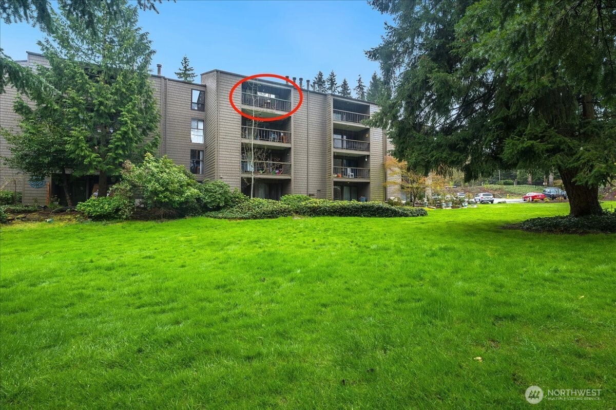 13680 Northeast 69th Street, Unit 656 Redmond, WA 98052 - Photo 3 of 33 a view of a house with a big yard and large trees