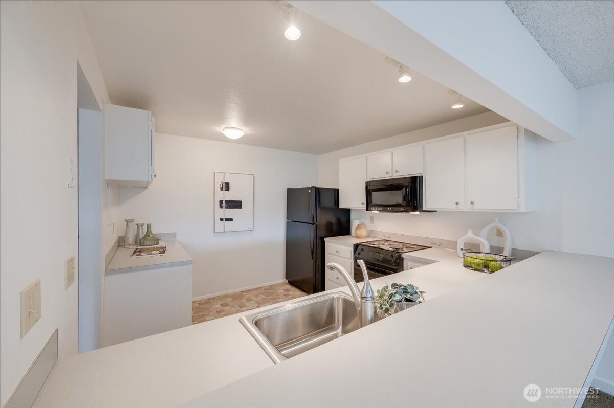 13680 Northeast 69th Street, Unit 656 Redmond, WA 98052 - Photo 6 of 33 a kitchen with stainless steel appliances cabinets a sink and a stove