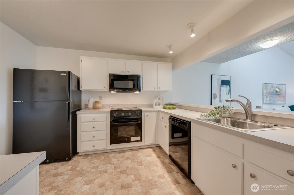 13680 Northeast 69th Street, Unit 656 Redmond, WA 98052 - Photo 8 of 33 a kitchen with stainless steel appliances granite countertop a refrigerator stove and sink