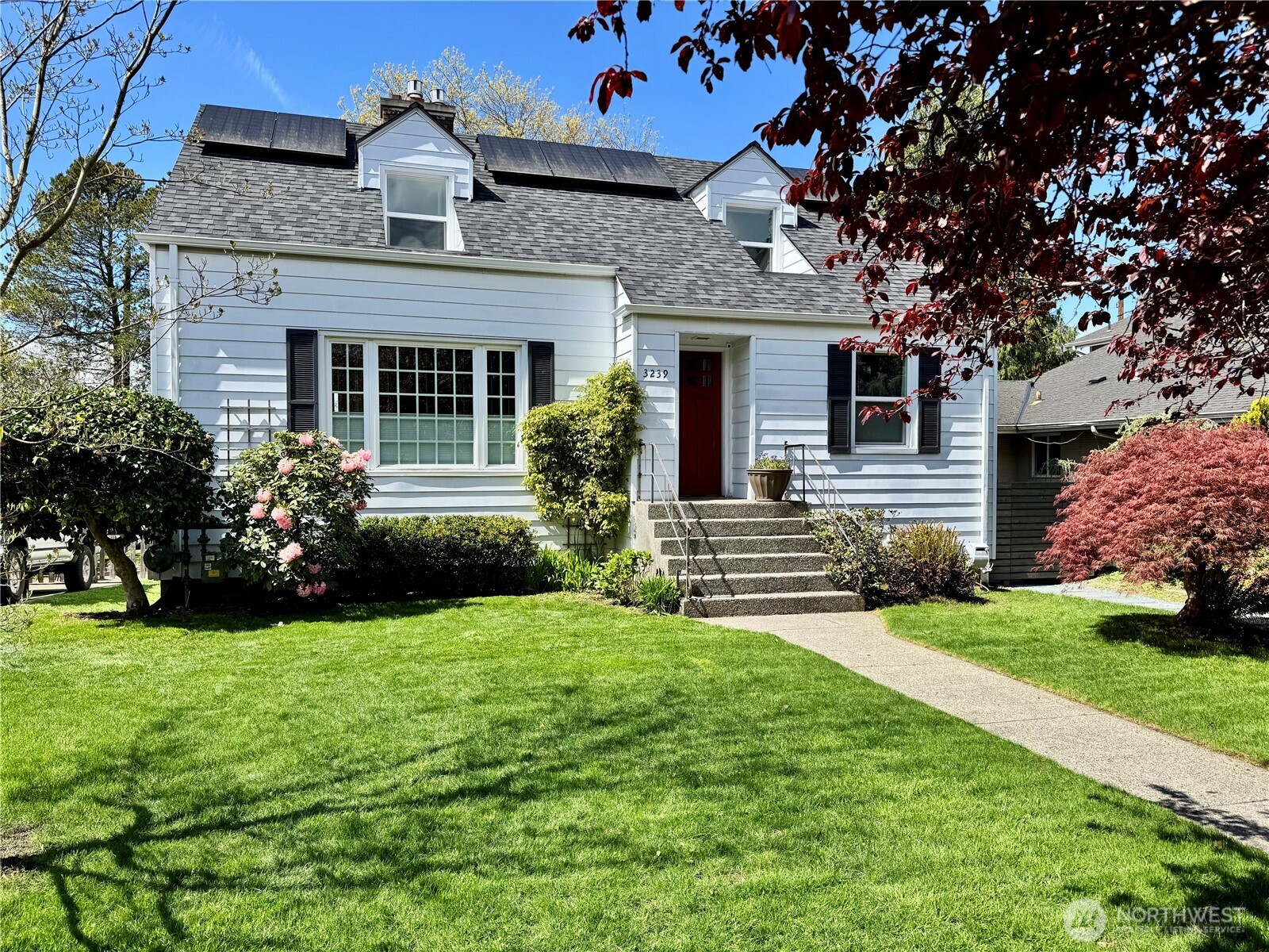 a front view of a house with a garden