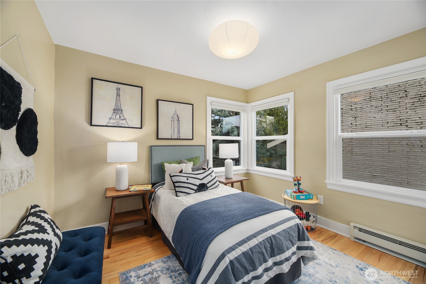 3239 45th Avenue Southwest Seattle, WA 98116 - Photo 12 of 39 a bedroom with a bed and wooden floor