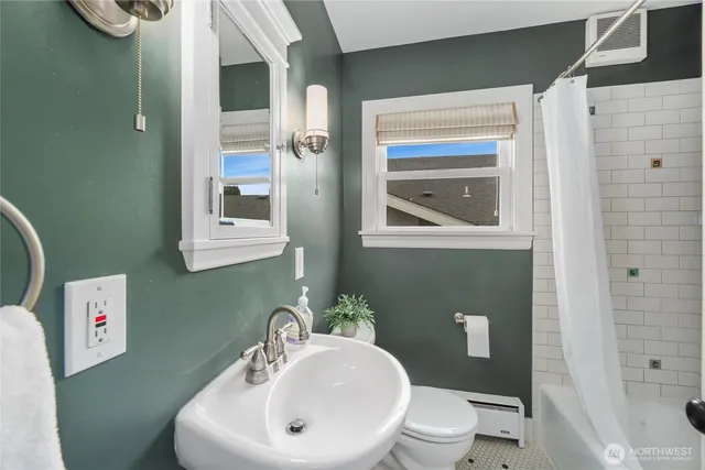 a bathroom with a toilet a sink and mirror