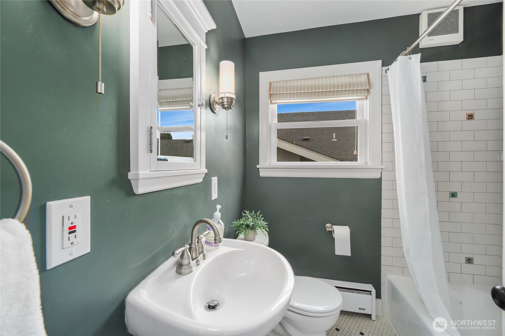 3239 45th Avenue Southwest Seattle, WA 98116 - Photo 13 of 39 a bathroom with a toilet a sink and mirror