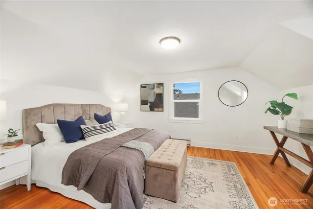 a bedroom with bed and a table