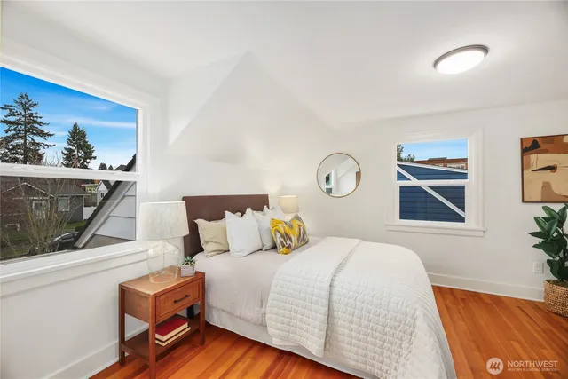 a bedroom with a bed and a painting on the wall