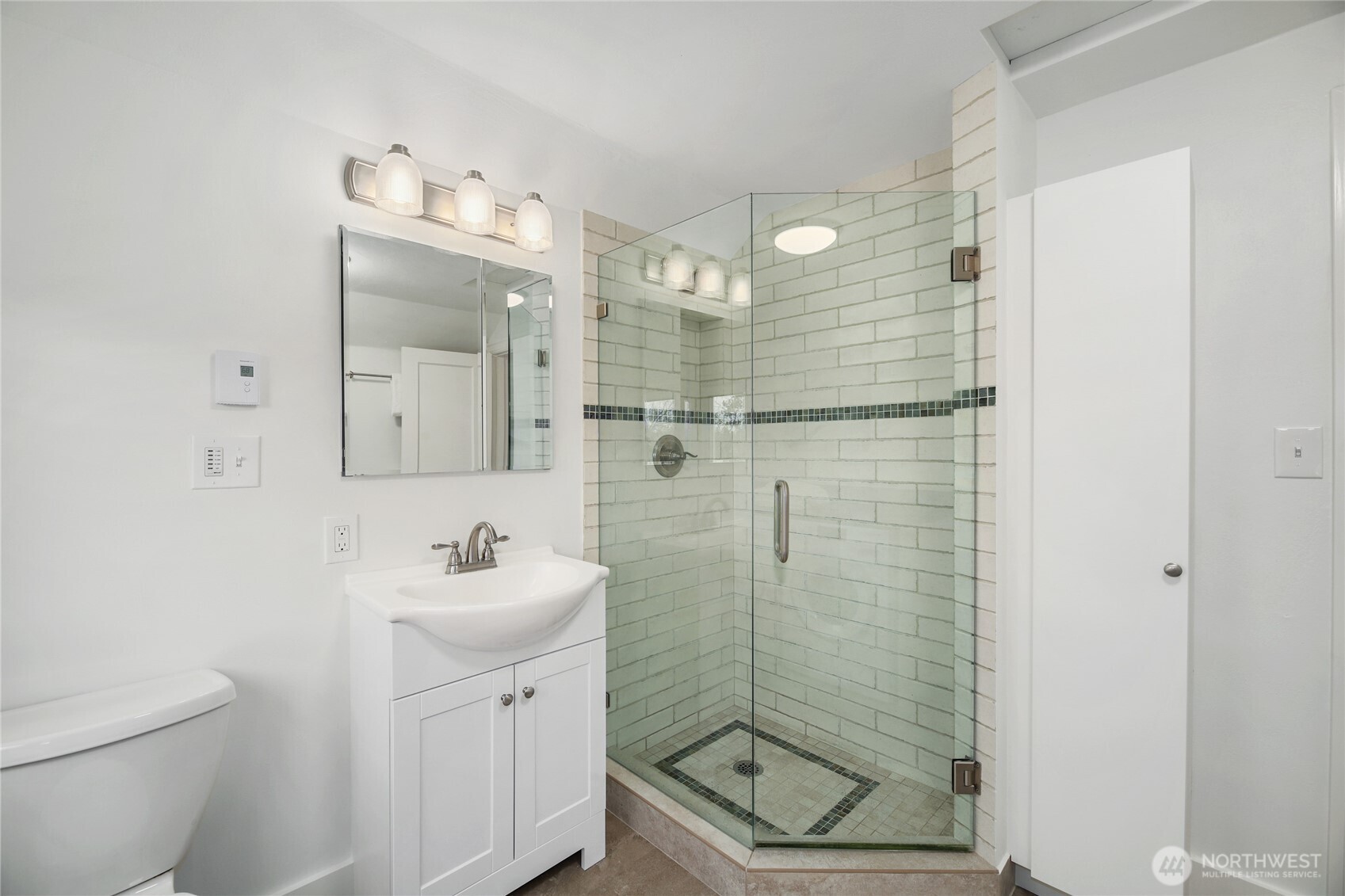 3239 45th Avenue Southwest Seattle, WA 98116 - Photo 18 of 39 a bathroom with a shower a sink a toilet and mirror