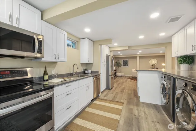 a kitchen with a sink a stove and cabinets