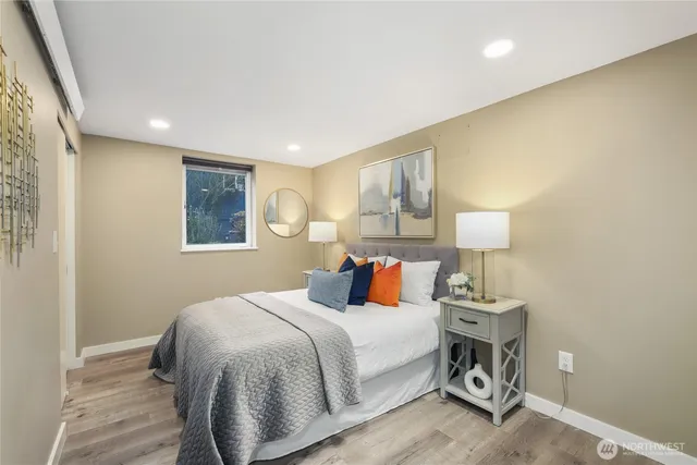 a bedroom with a bed and a night stand