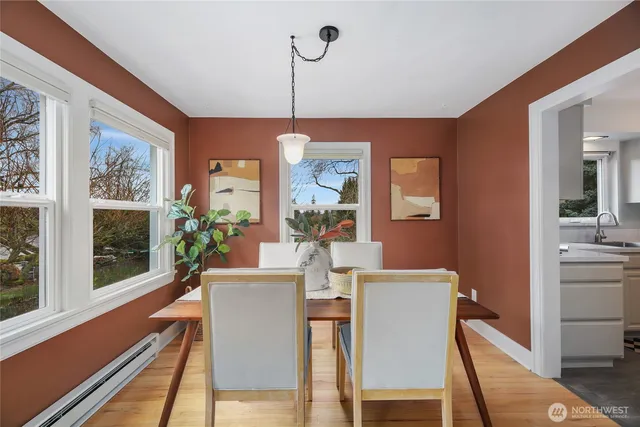 a dining room with furniture a chandelier and wooden floor