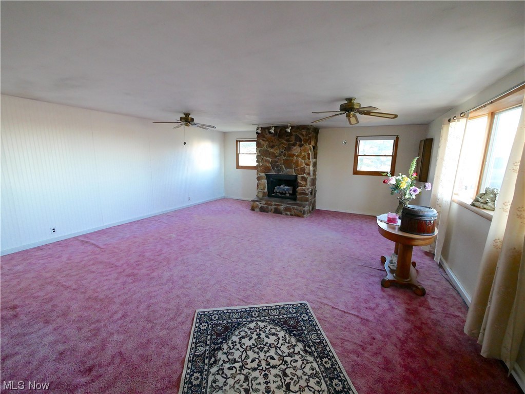 61784 Ray Ramsey Road Shadyside, OH 43947 - Photo 10 of 29 Living room with ceiling fan, a fireplace, and carpet floors
