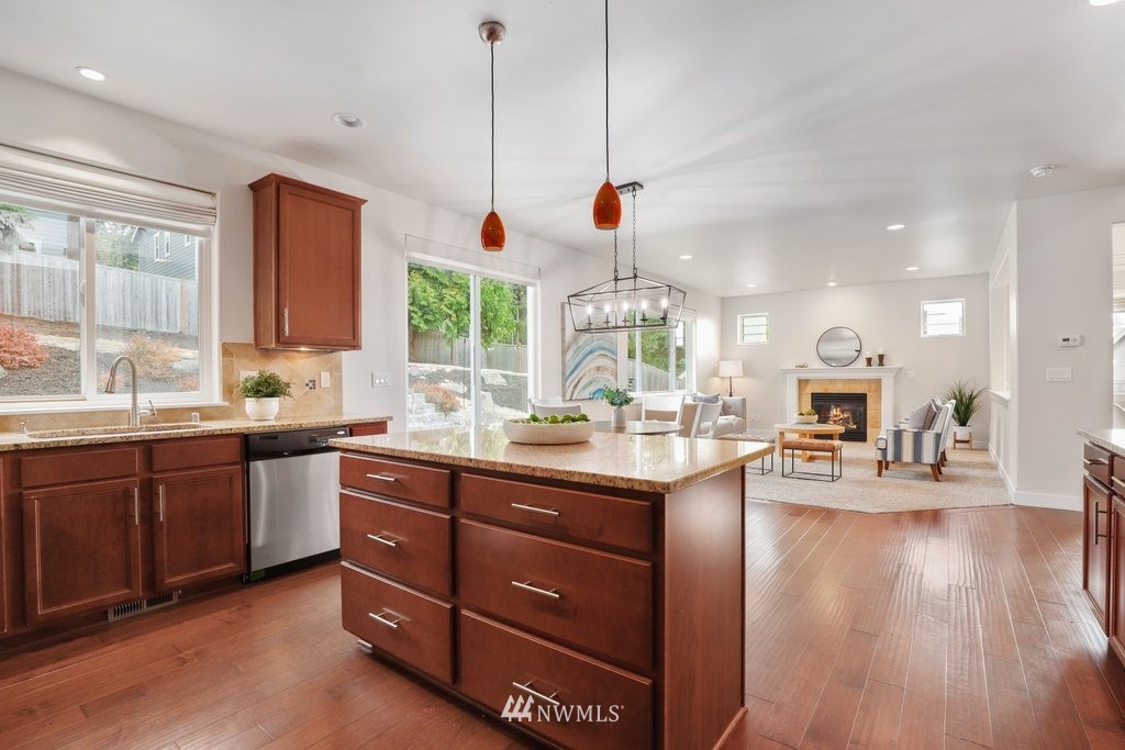 113 233rd Place Southeast Bothell, WA 98021 - Photo 11 of 39 a kitchen with stainless steel appliances granite countertop wooden cabinets a stove and a wooden floors
