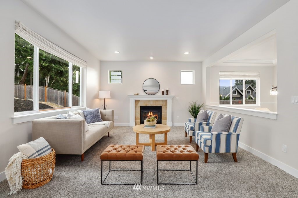 113 233rd Place Southeast Bothell, WA 98021 - Photo 13 of 39 a living room with furniture a fireplace and a large window