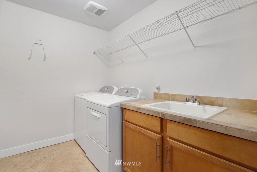 113 233rd Place Southeast Bothell, WA 98021 - Photo 28 of 39 a utility room with a sink washer and dryer