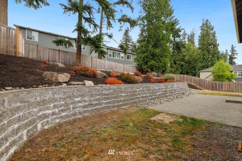 113 233rd Place Southeast Bothell, WA 98021 - Photo 30 of 39 a view of a yard with plants and trees
