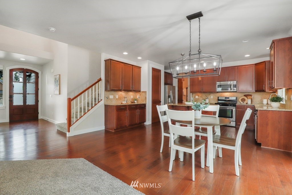 113 233rd Place Southeast Bothell, WA 98021 - Photo 5 of 39 a view of a dining room with furniture wooden floor and chandelier