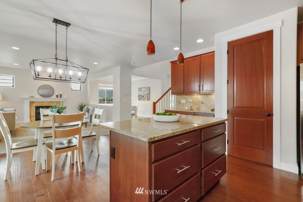 113 233rd Place Southeast Bothell, WA 98021 - Photo 10 of 39 a kitchen with stainless steel appliances granite countertop wooden floors and a view of living room