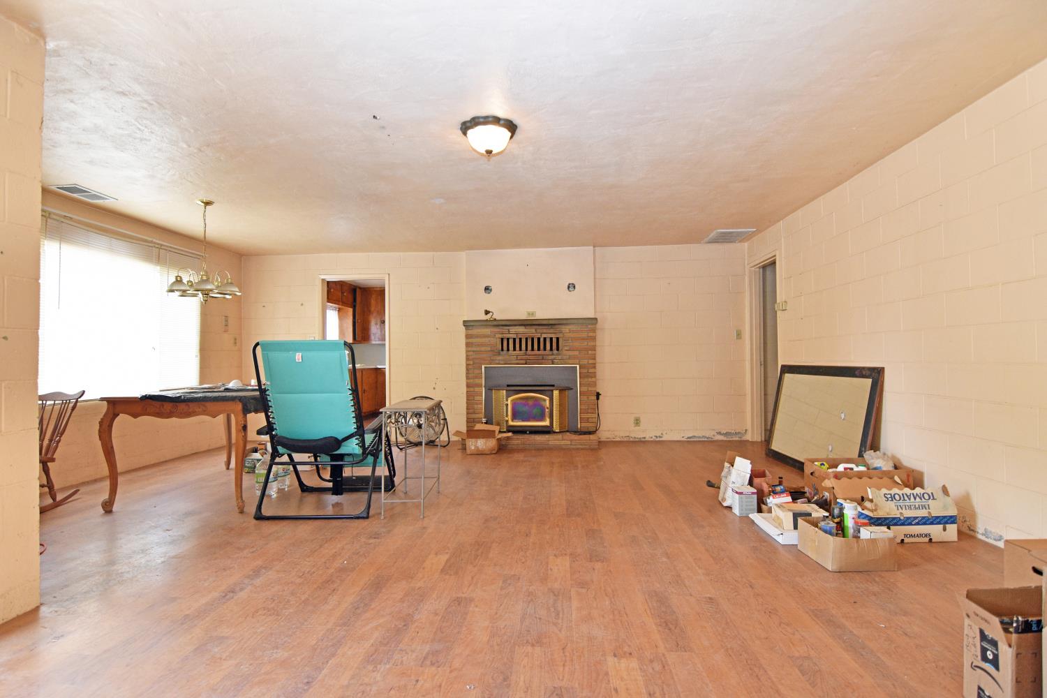 1206 South Verduga Road Turlock, CA 95380 - Photo 6 of 36 a view of a livingroom with furniture and a fireplace