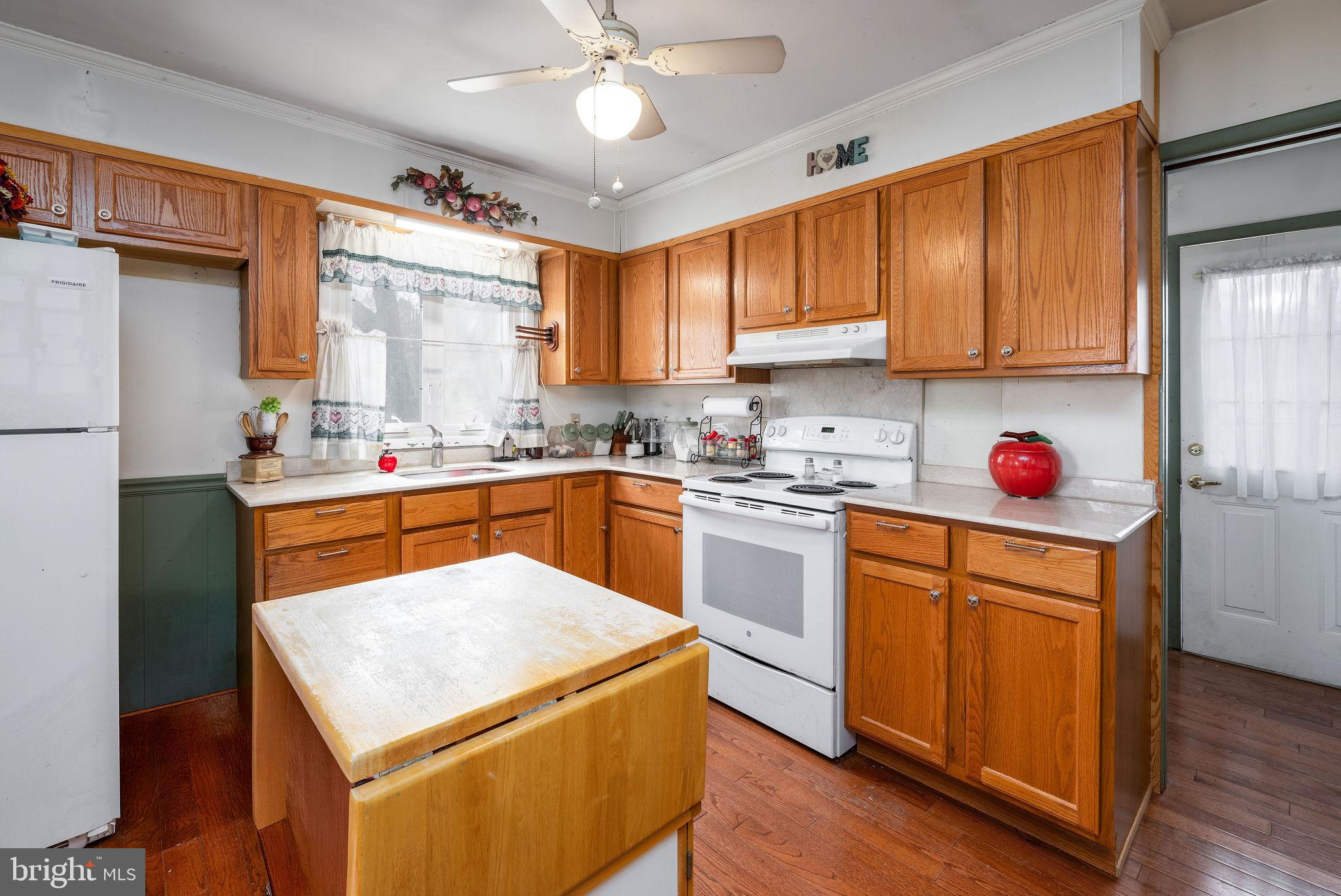 29618 Armory Road Dagsboro, DE 19939 - Photo 11 of 37 a kitchen with granite countertop a sink appliances cabinets and counter space