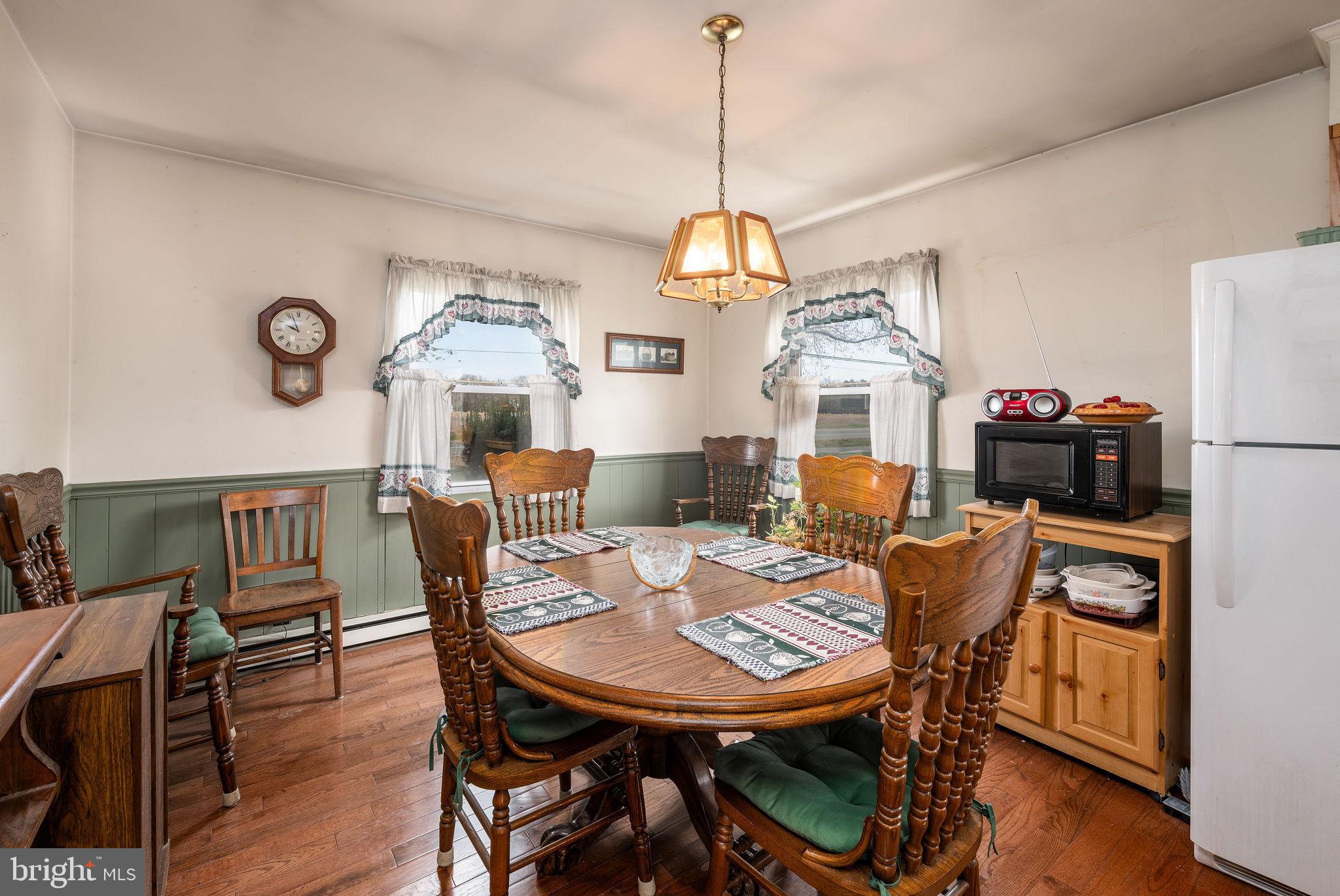 29618 Armory Road Dagsboro, DE 19939 - Photo 12 of 37 a view of a dining room with furniture window and wooden floor