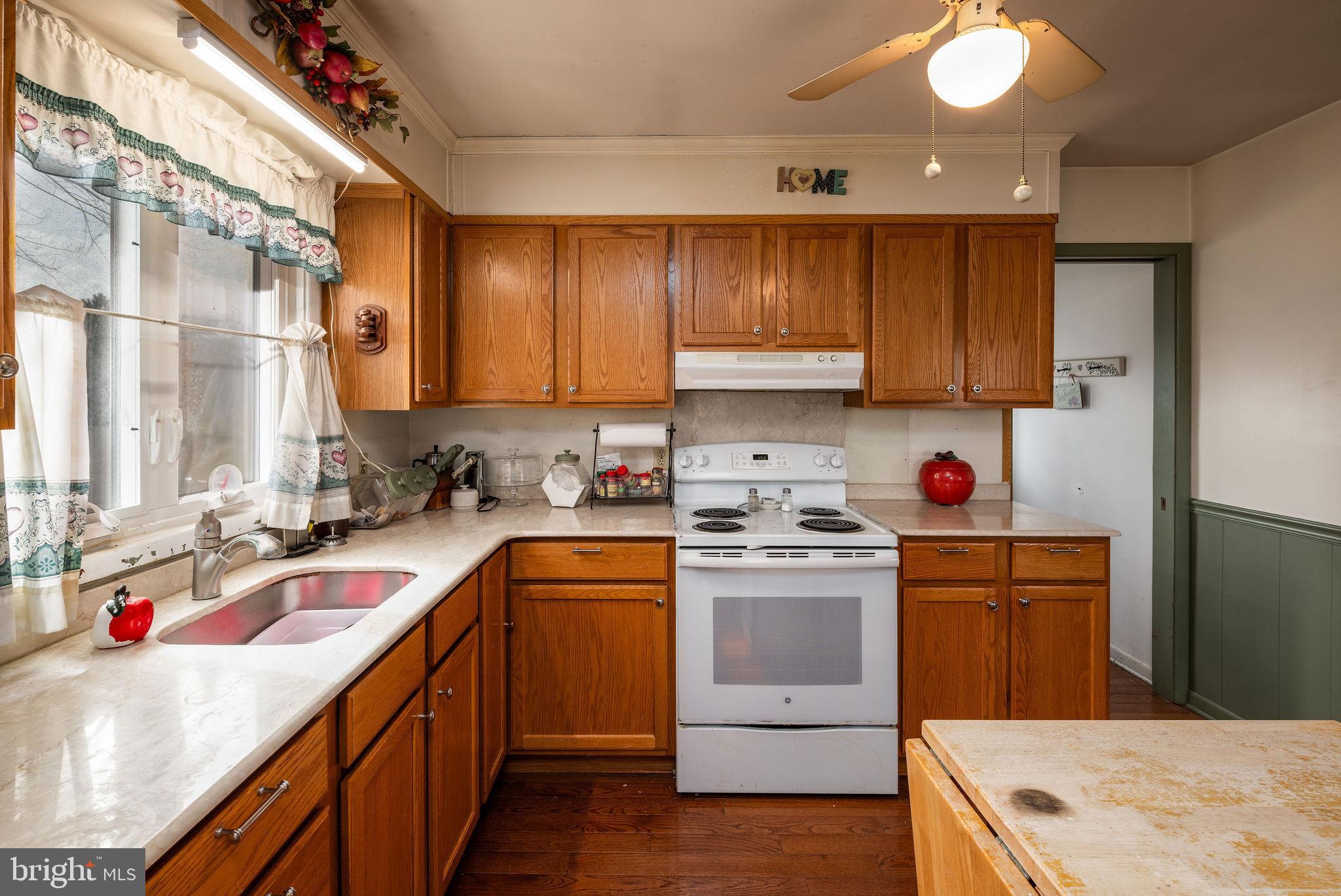 29618 Armory Road Dagsboro, DE 19939 - Photo 14 of 37 a kitchen with a sink stove top oven and cabinets