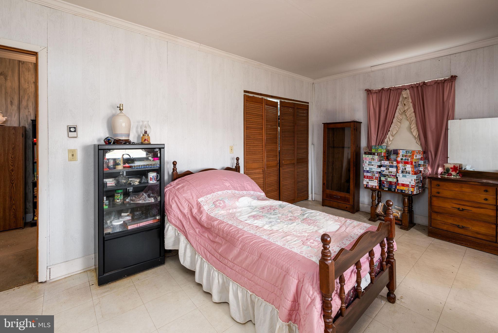 29618 Armory Road Dagsboro, DE 19939 - Photo 26 of 37 a bedroom with a bed and a closet