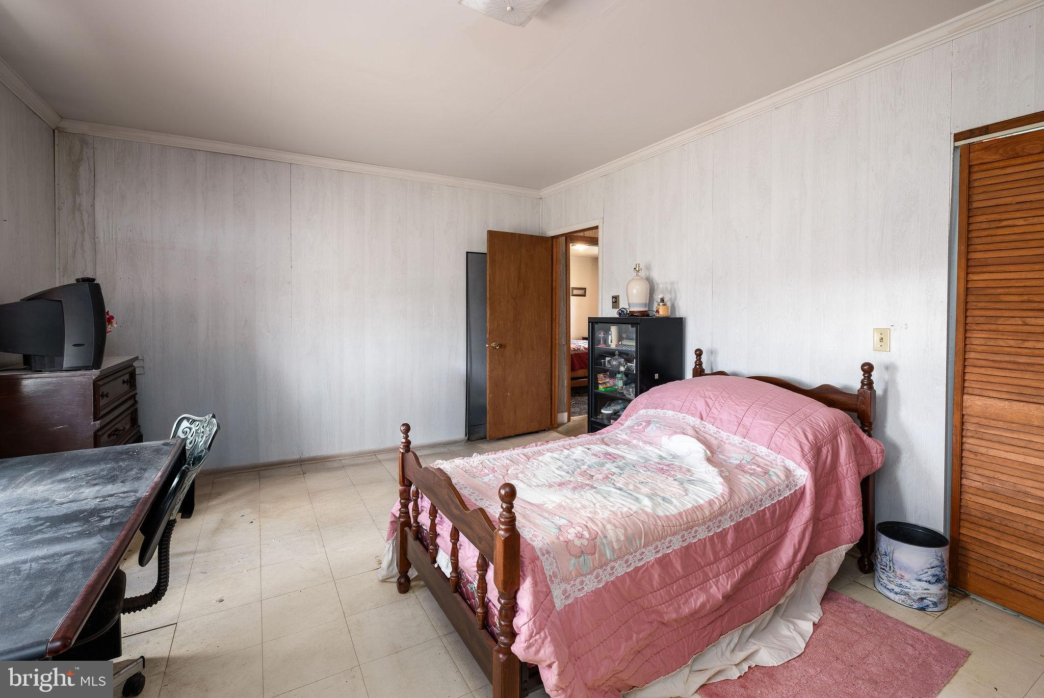29618 Armory Road Dagsboro, DE 19939 - Photo 27 of 37 a bedroom with a bed and wooden floor