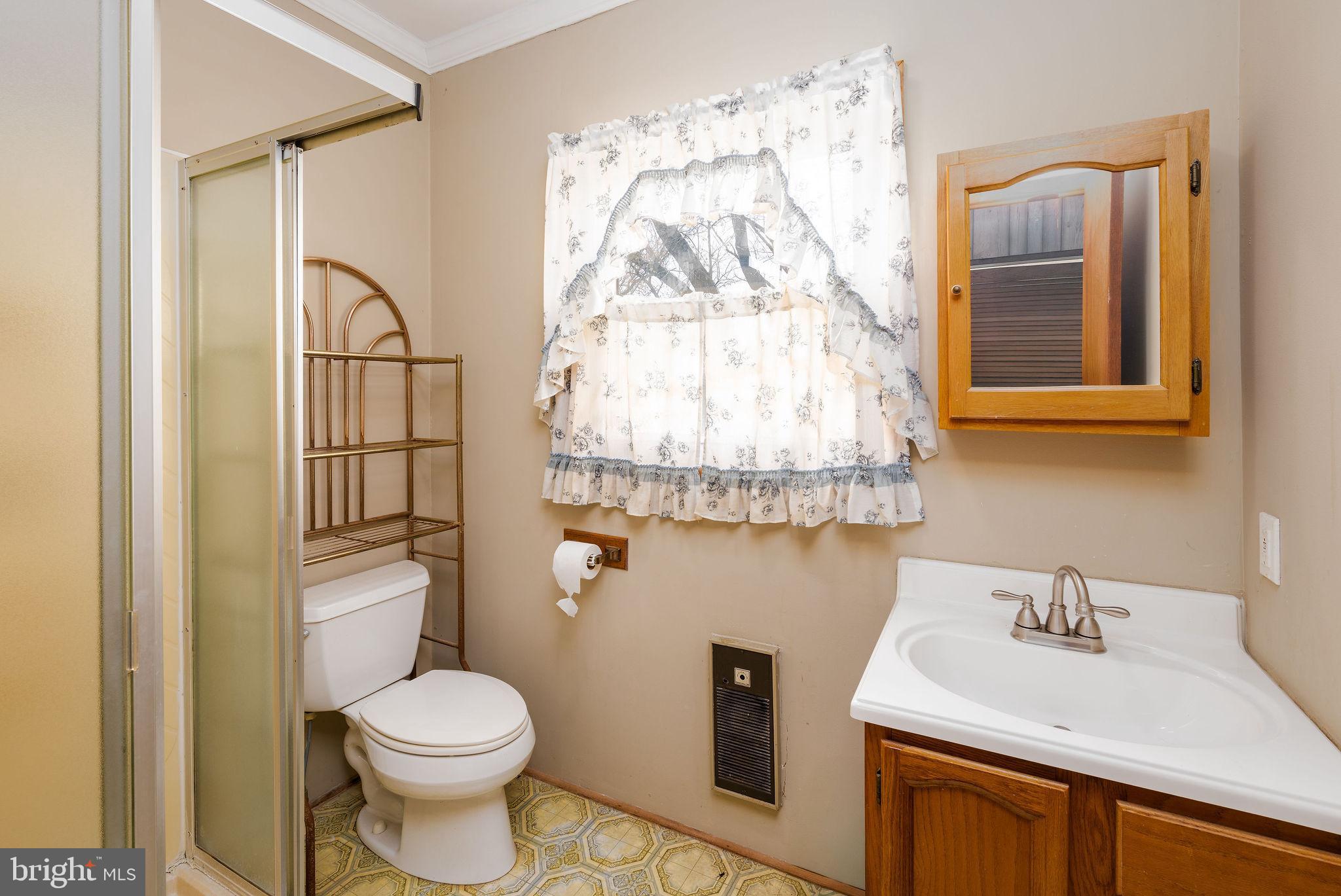 29618 Armory Road Dagsboro, DE 19939 - Photo 28 of 37 a bathroom with a sink toilet and shower