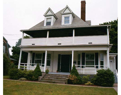 a front view of a house with garden and porch