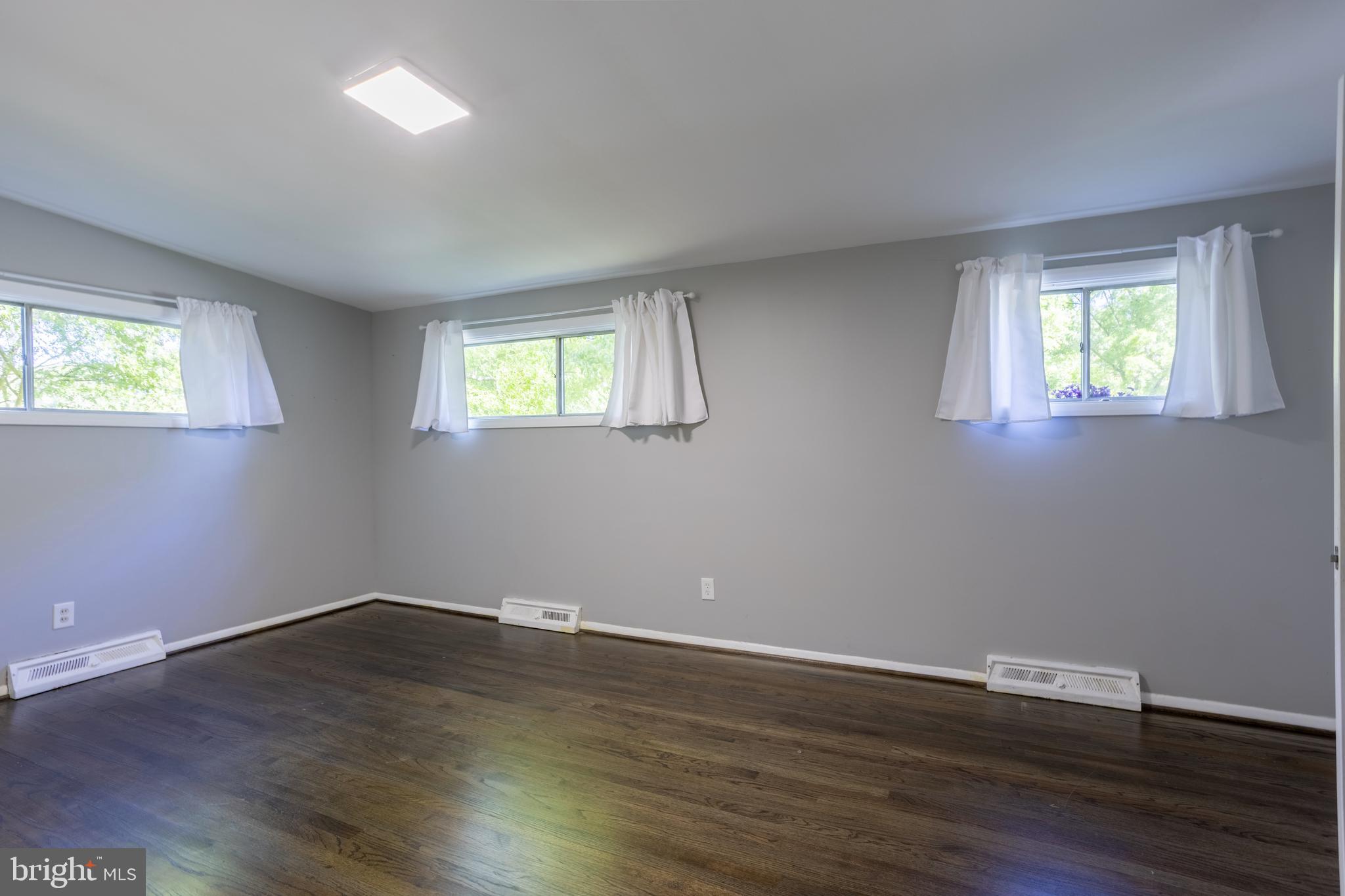 3207 Midfield Road Pikesville, MD 21208 - Photo 19 of 45 a view of a room with wooden floor and two window