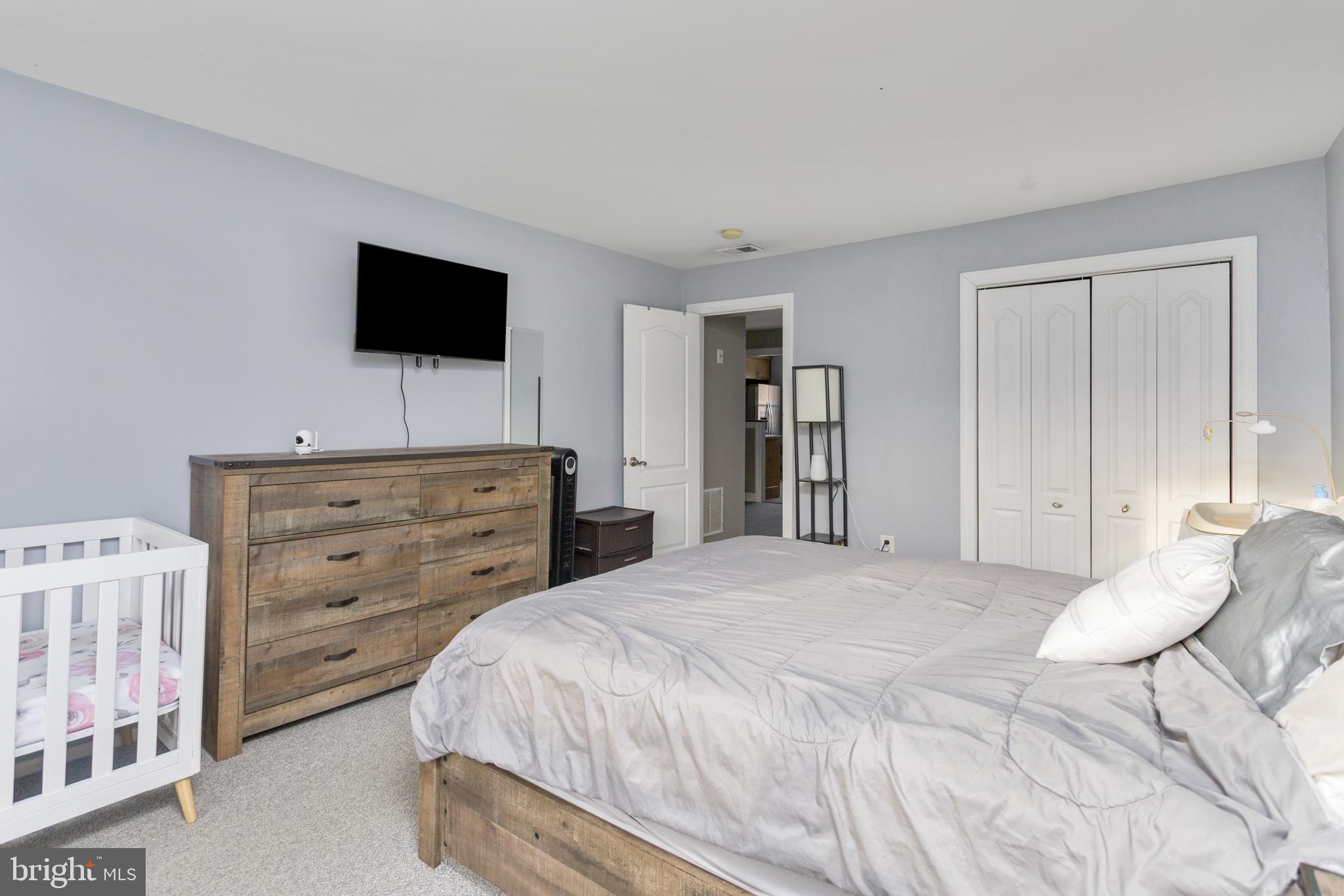 912 Silver Court Hamilton, NJ 08690 - Photo 16 of 22 a bedroom with a bed and a flat screen tv