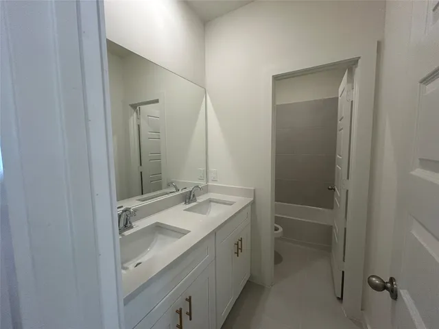 a bathroom with a sink a mirror and a shower