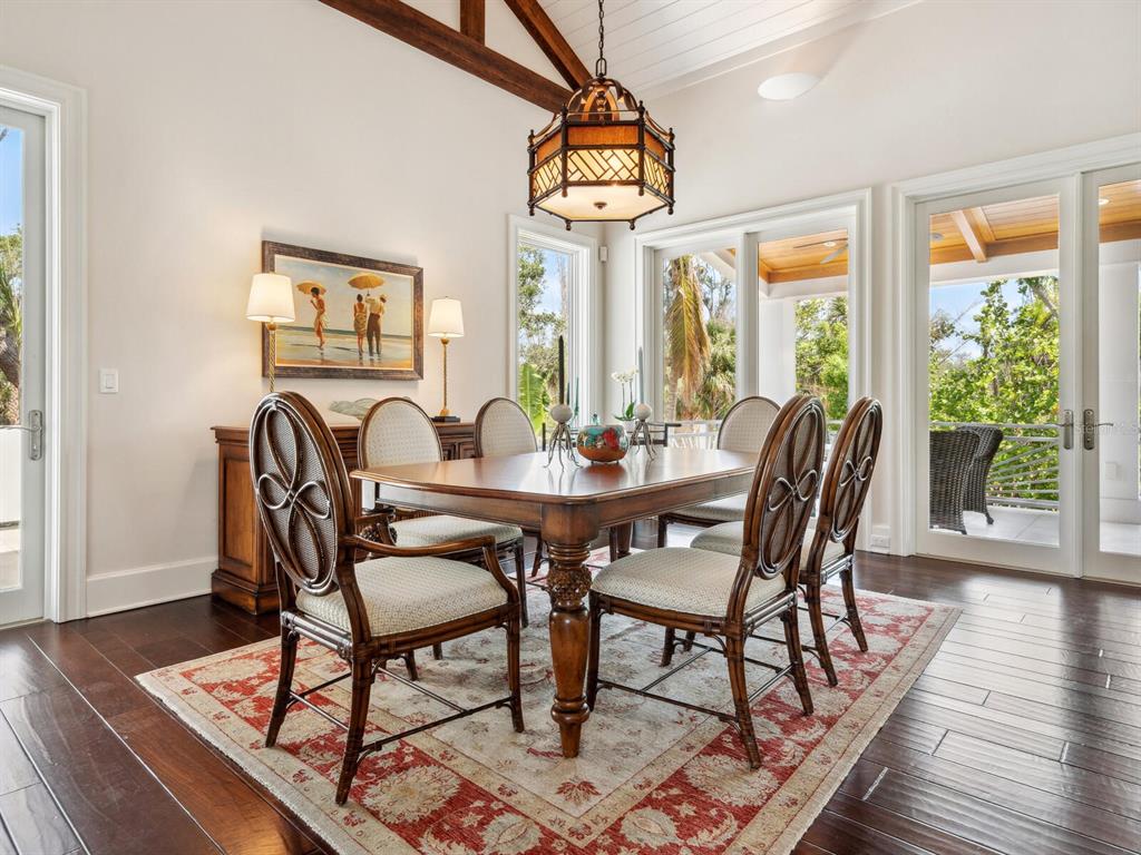 7333 Point Of Rocks Road Sarasota, FL 34242 - Photo 14 of 81 a view of a dining room with furniture wooden floor and chandelier