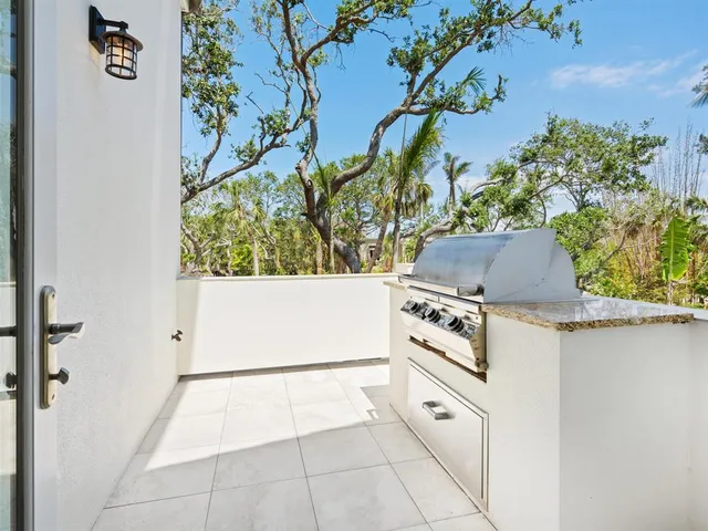 a bathroom with a sink a washer and dryer next to a window